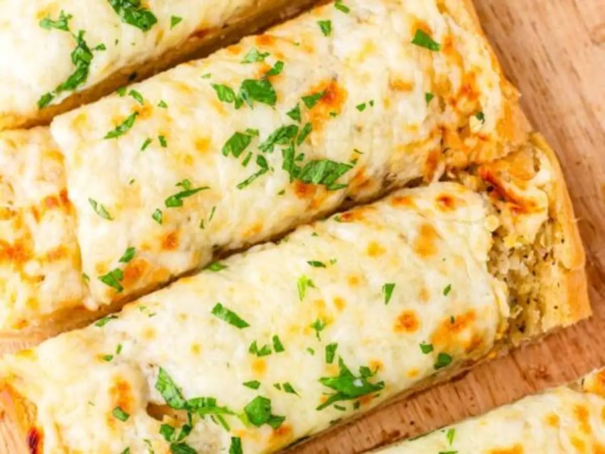 Step-by-Step Recipe for Garlic Bread
Preparation Time: 10 minutes
Cooking Time: 15 minutes
Total Time: 25 minutes
Servings: 4
Ingredients:
1 French baguette or Italian loaf
1/2 cup unsalted butter, softened
4 cloves garlic, minced
1/4 cup fresh parsley, chopped
Salt and pepper to taste
Optional: 1/2 cup shredded mozzarella cheese
Instructions:
Preheat the Oven: Begin by preheating your oven to 375°F (190°C). This ensures that your garlic bread will bake evenly and achieve the perfect crispiness.
Prepare the Garlic Butter: In a mixing bowl, combine the softened butter, minced garlic, chopped parsley, salt, and pepper. Mix well until all ingredients are fully incorporated. If you’re using cheese, you can also fold it into the mixture at this stage.
Slice the Bread: Take your loaf and slice it in half lengthwise. If you prefer individual servings, you can slice it into smaller pieces. This will help the garlic butter penetrate the bread better.
Spread the Mixture: Generously spread the garlic butter mixture over the cut sides of the bread. Make sure to cover every inch for maximum flavor.
Bake the Bread: Place the bread halves on a baking sheet, cut side up. Bake in the preheated oven for about 10-15 minutes, or until the edges are golden and crispy. If you want a more toasted finish, you can switch to broil for the last 2-3 minutes, but watch closely to prevent burning.
Serve: Remove the garlic bread from the oven and let it cool for a minute. Slice into pieces and serve warm. Enjoy the aromatic and delicious flavors with your favorite meal!
Creative Variations of Garlic Bread
While the classic recipe is divine, there are many ways to put a unique spin on garlic bread:
Cheesy Garlic Bread: Top with mozzarella or cheddar cheese before baking for a gooey, indulgent treat.
Herbed Garlic Bread: Mix in different fresh herbs like thyme, basil, or rosemary for an aromatic twist.
Spicy Garlic Bread: Add red pepper flakes or minced jalapeños for a kick.
Serving Suggestions and Pairings
Garlic bread pairs beautifully with a variety of dishes. Serve it alongside spaghetti, lasagna, or a hearty soup for a comforting meal. You can also use leftover garlic bread to make delicious croutons for salads or transform it into a sandwich with your favorite fillings.
With this ultimate garlic bread recipe, you’re well on your way to impressing family and friends with a side dish that’s simple yet incredibly flavorful. Whether you're enjoying a cozy dinner at home or hosting a gathering, this garlic bread is sure to be a hit! Enjoy cooking with Sophia AI Chef at Starlight Recipes, and elevate your dining experience with this timeless classic.